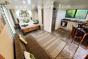 Inside the bungalow showing the Kind bed, kitchen and lounge area