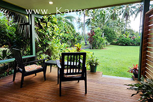 View from the wooden veranda showing spacious landscaped gardens
